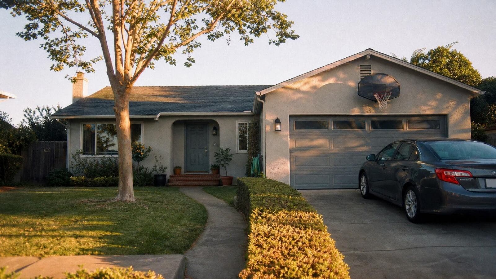 A well-kept modest California suburban home at golden hour that has clearly gained value.