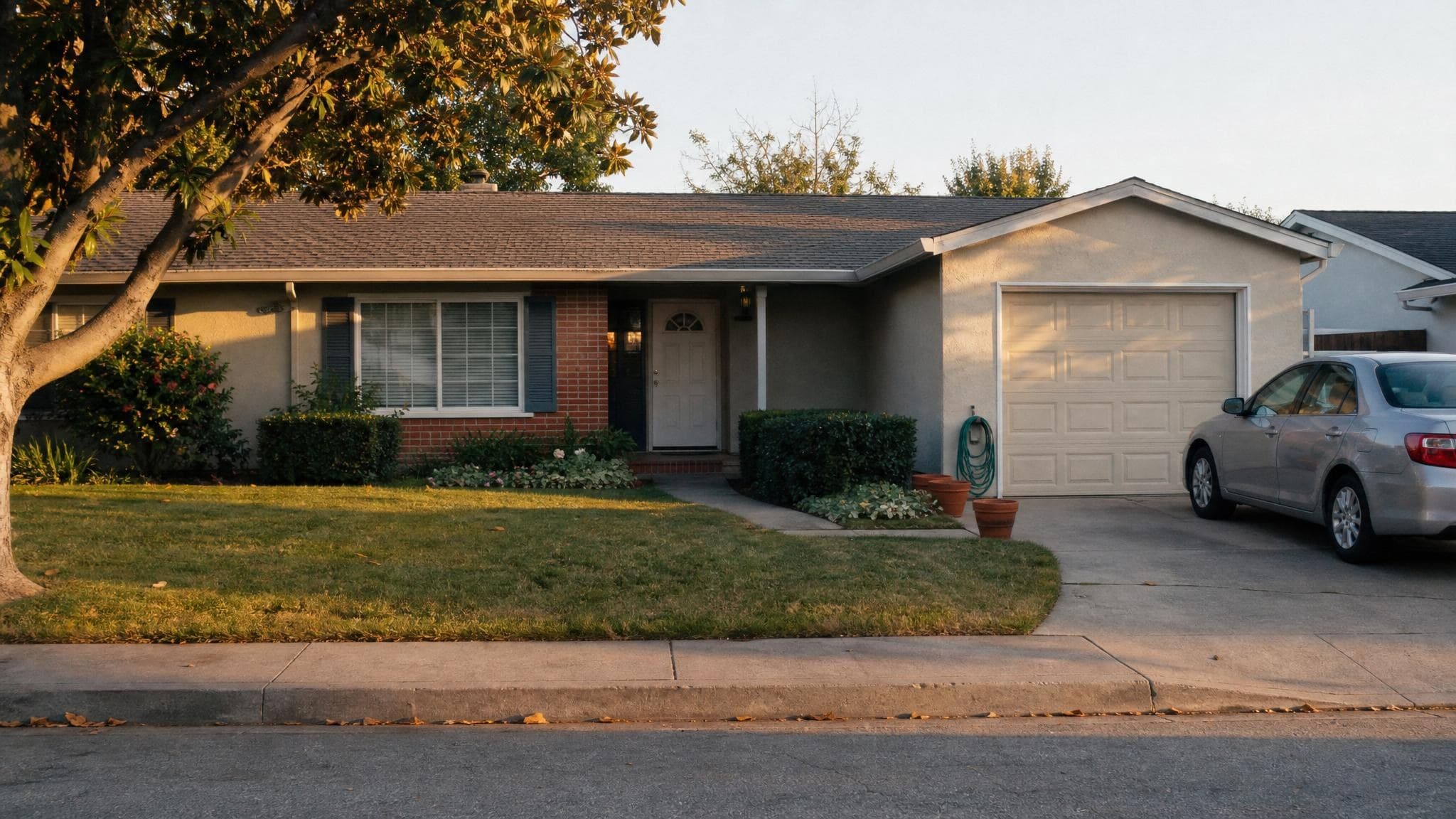 A settled single-story California ranch home on a quiet suburban street at golden hour.